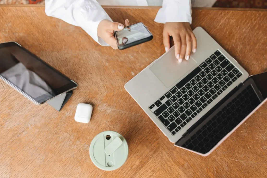 person multitasking with digital devices