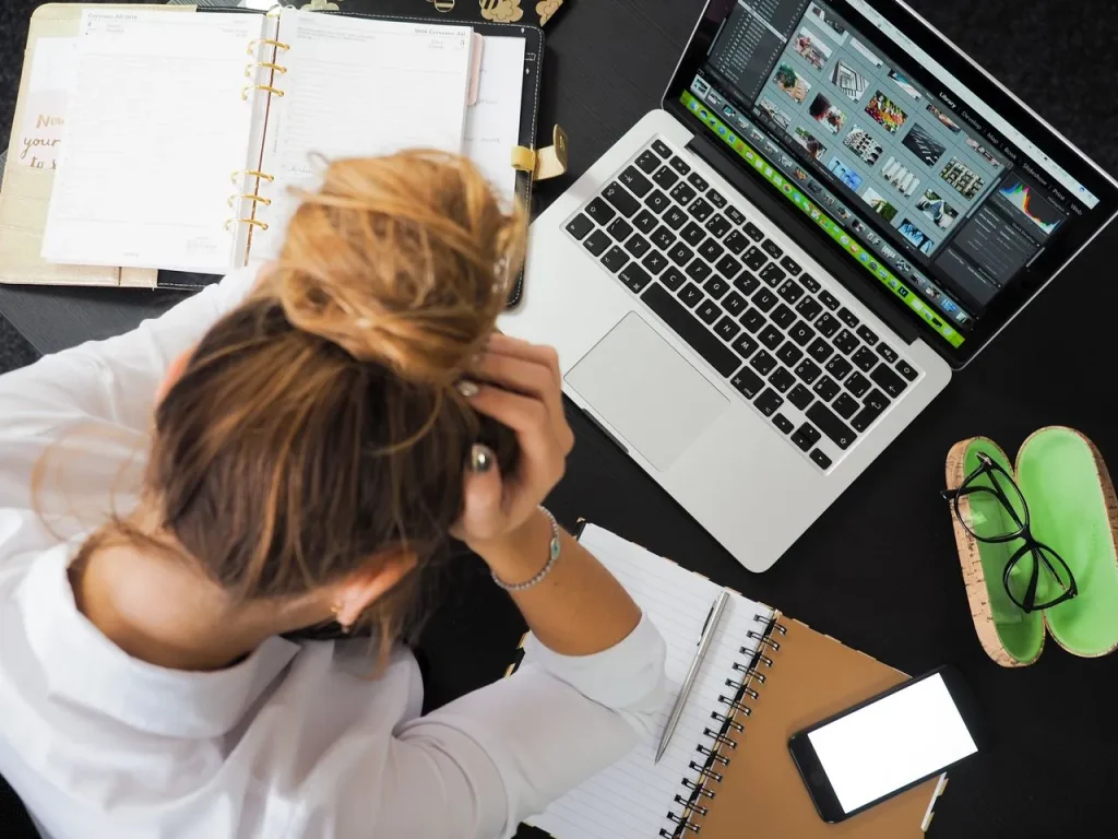 Person feeling overwhelmed while working on a difficult task